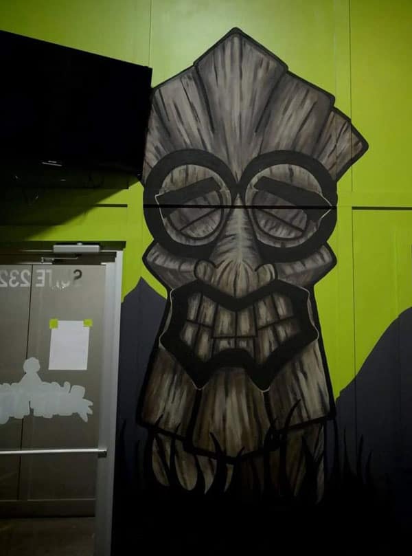 Amanda Bouldin's Parade Creations - Wall painted with Tiki - Background scenery design. Painting including blacklight, texture, and airbrushing.