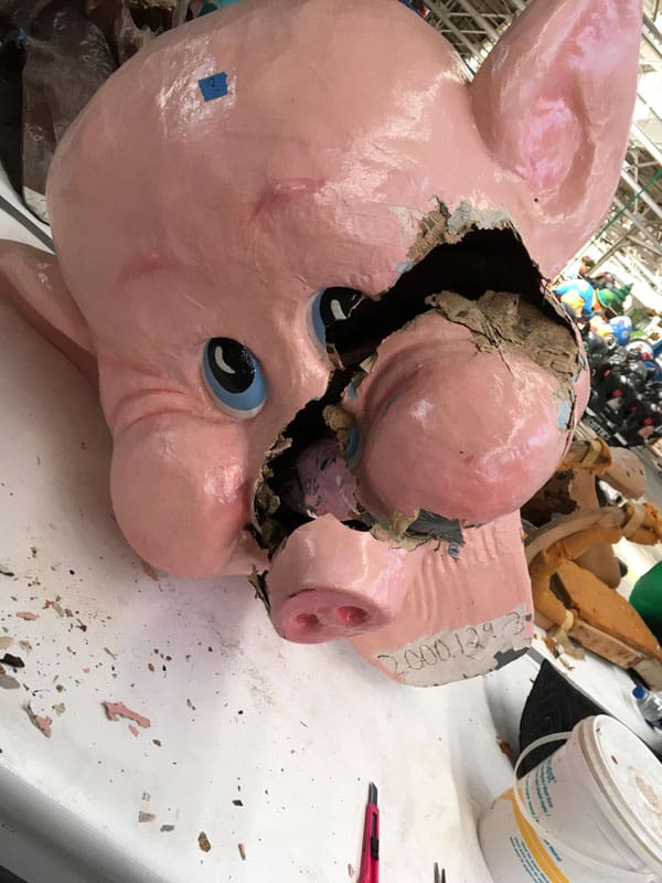 Amanda Bouldin's Parade Creations and Restorations - Lil Piggie - Restoration work on paper mâché pig head with significant damage.